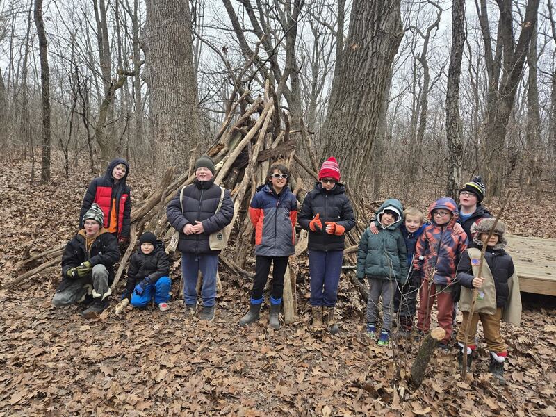 Kids standing together in the woods after an outdoor activity